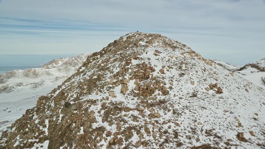 Rocky mountain peaks covered in snow on a cloudy day