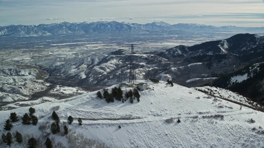 Transmission towers on the peak of a snowy mountain