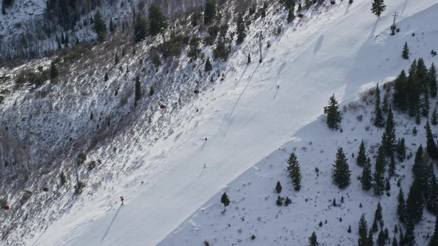 People skiing down the snowy slopes of a mountain