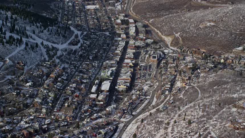The town at the bottom of the mountain is covered with snow