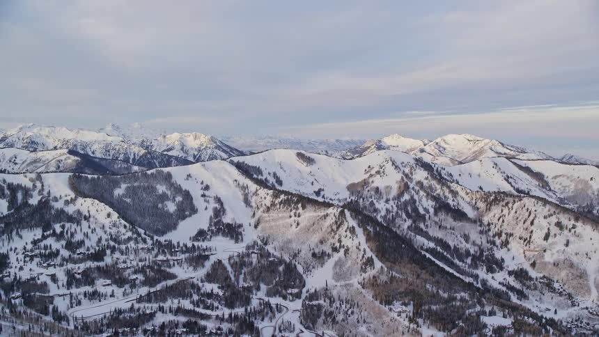 Mountain top covered in snow at midday