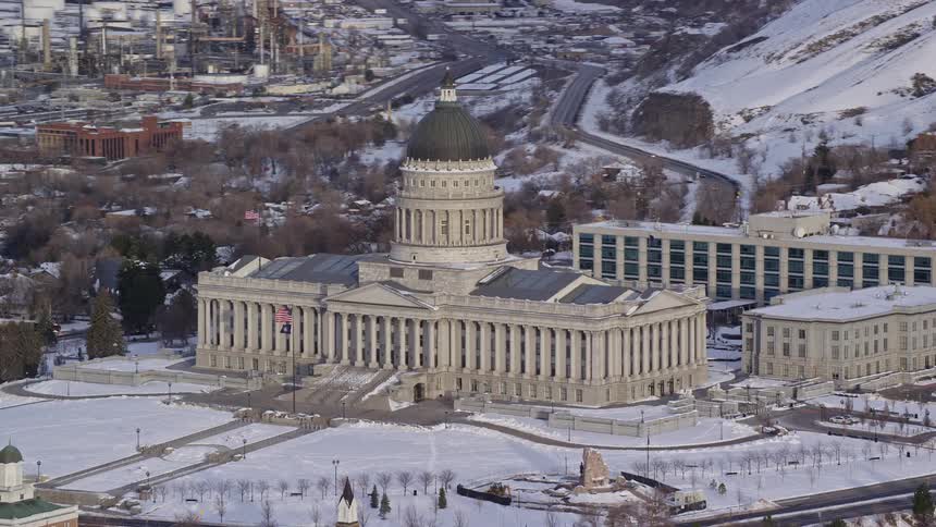 Aerial panorama of a congress building next to a mountain covered in snow