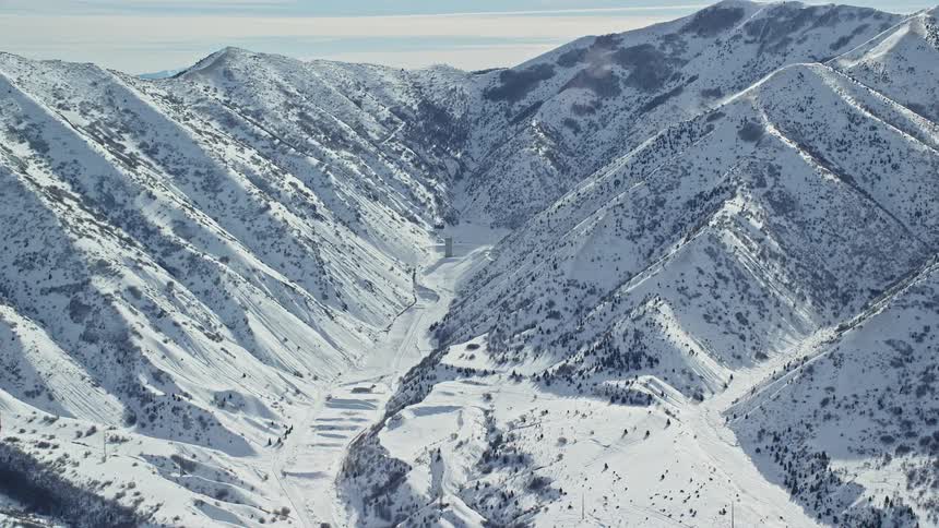 Aerial view of a snowy mountain ridge and a valley