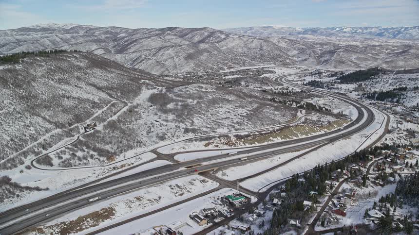 Aerial panorama of a road along snowcovered mountains