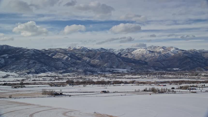 Skyline of a rural town with snowcapped mountains during winter