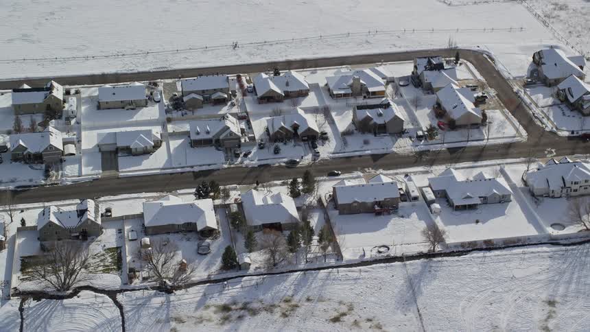 Aerial view of a residential neighborhood covered in snow
