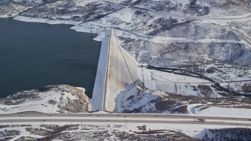 Aerial view of a dam in the snowy mountains