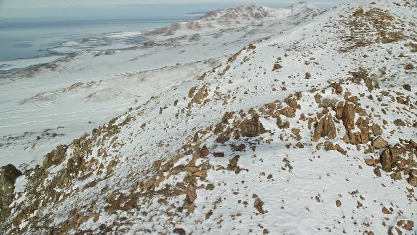 Skyline of a rocky mountain with snow on the peak