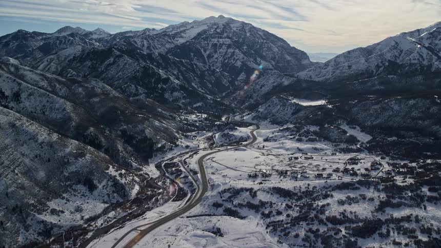 A small village surrounded by frozen mountains during winter