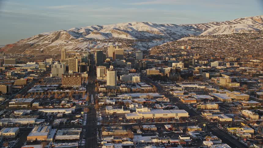 A large city with small buildings and a center with tall buildings and a cold snowy climate