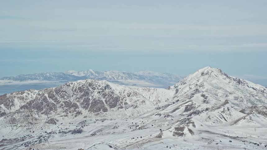 Aerial panorama of mountains and peaks with snow on a morning