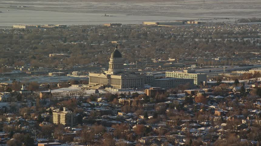 Aerial view of a city with a lake behind it