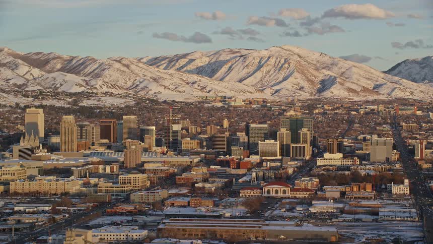 Aerial view of cityscape and distant snowy mountain range