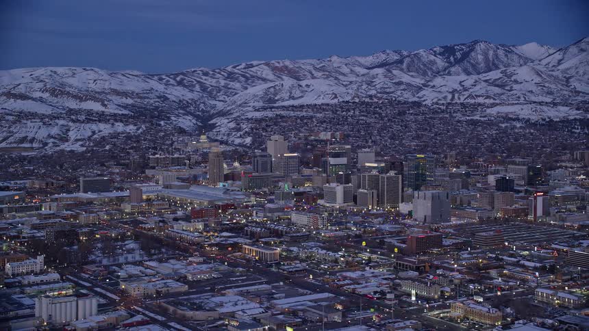 An aerial view of a city with some tall buildings in a cold climate with snow on the ground