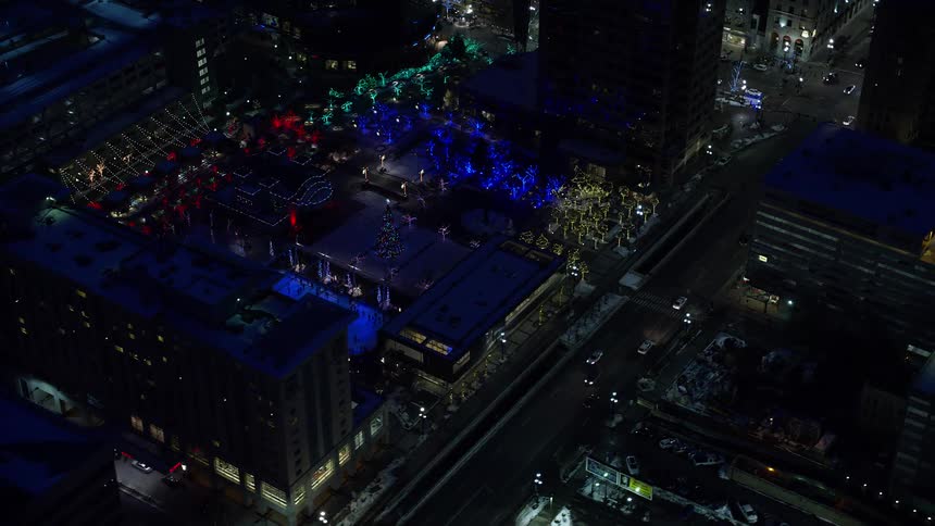Snow skating rink amidst a metropolis at night