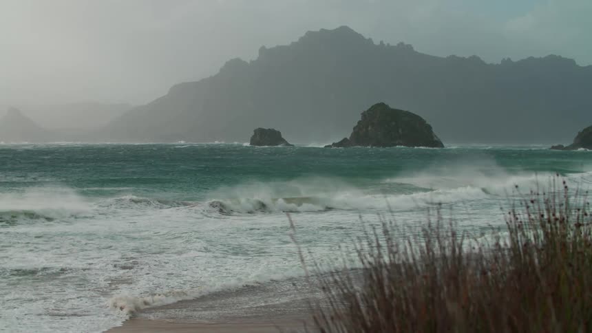 Ocean waves breaking against the beach