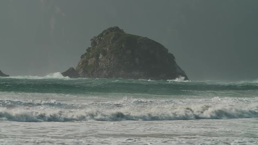 Waves of rough sea reaching the shore on the coast