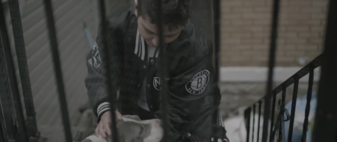 A dog greets an owner on the steps