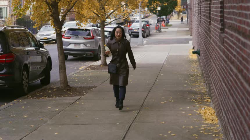 A woman walking through the streets of a neighborhood
