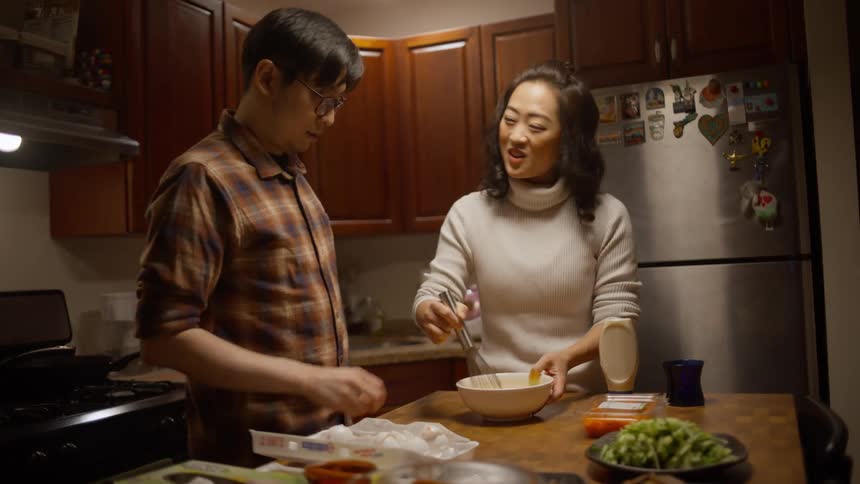 A woman and a man preparing a meal at home
