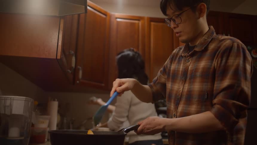Couple cooking a meal in the kitchen at home