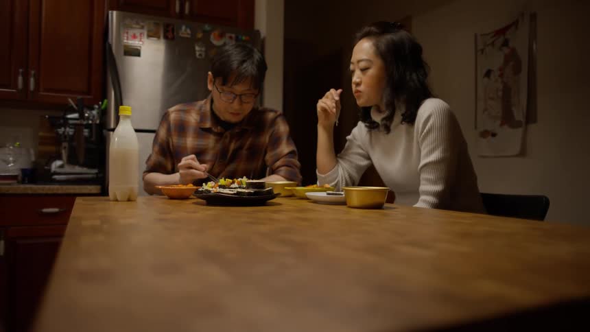 A couple eating at the kitchen table