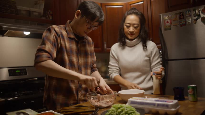 A man and a woman prepare a meal together