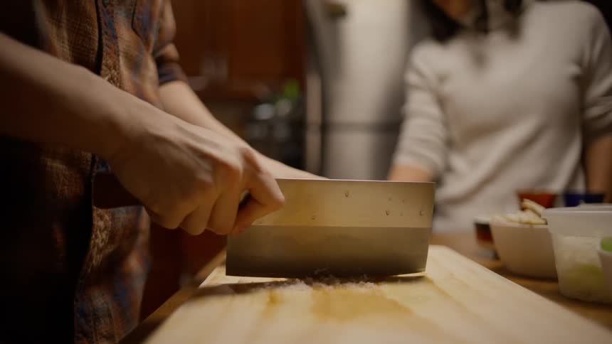 A person cutting ingredients for a meal