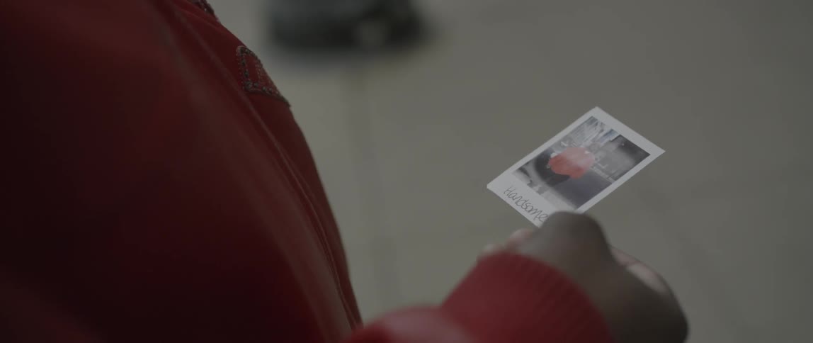 A person looks at a polaroid