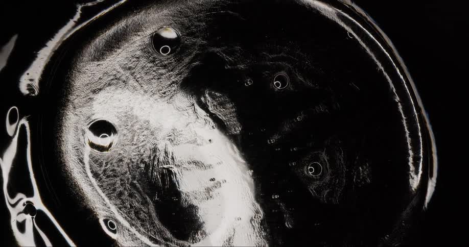Extreme closeup of a dense liquid bubble in black and white