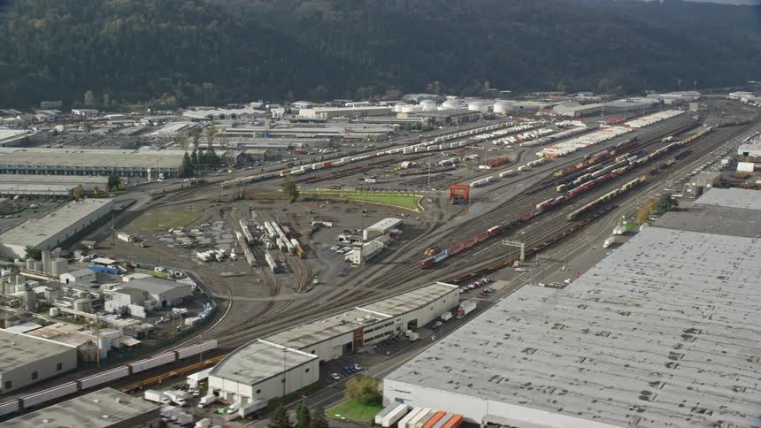 Aerial panorama of a logistics center with railway train trucks and vehicles