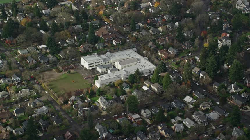 Aerial view of a residential neighborhood with intersections streets and cars