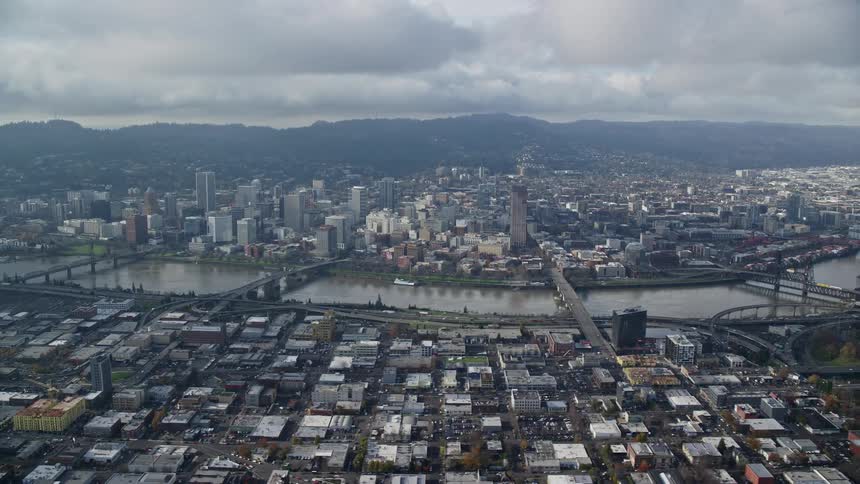 Aerial of an urban city with a waterway running through the middle of the city