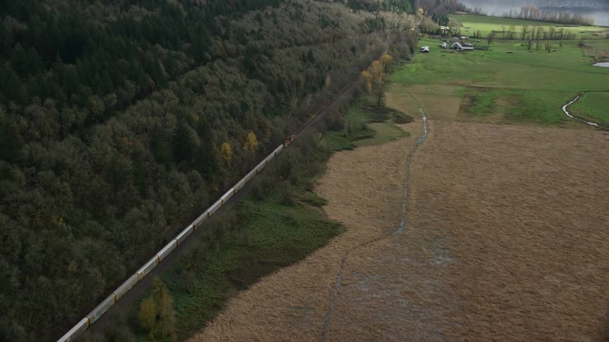 A train passes by the farm