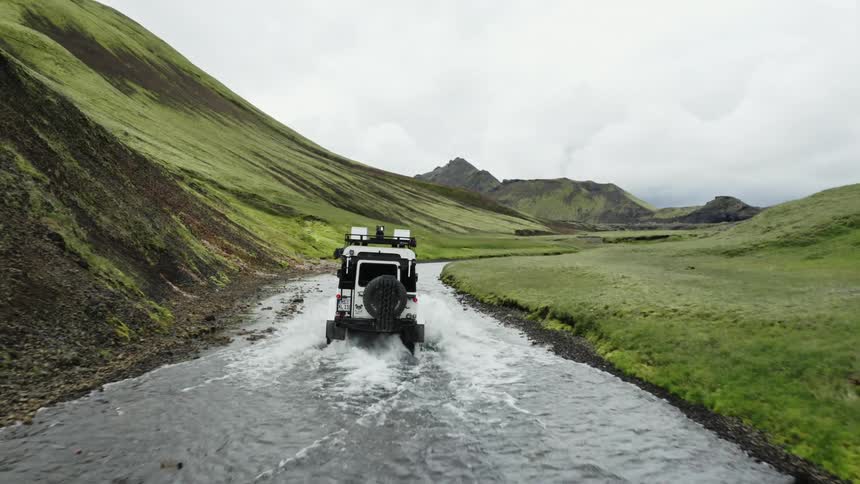 A jeep traveling the mountain through the water path