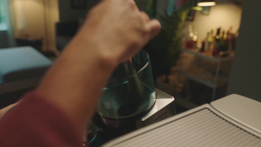 A person preparing coffee in a coffee machine