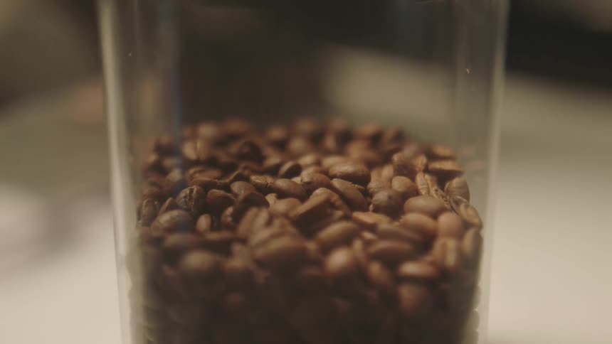 Close up of coffee beans in a glass jar