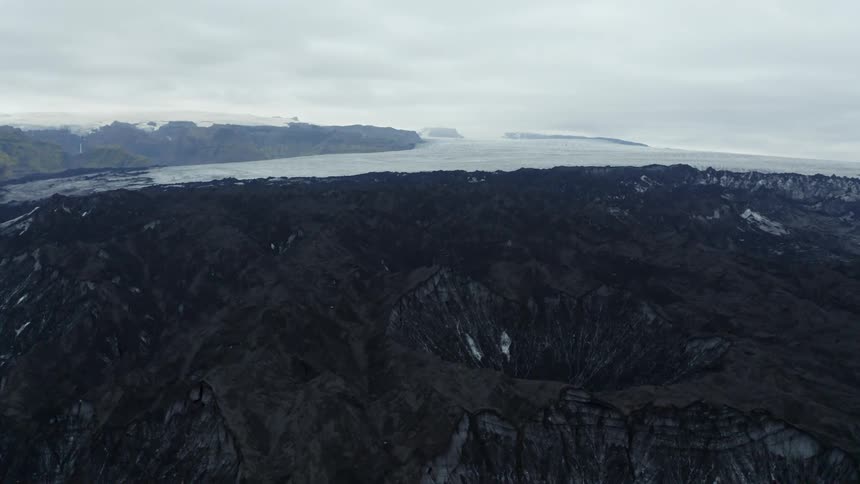 Aerial panorama of mountains and craters by the sea on a cloudy day
