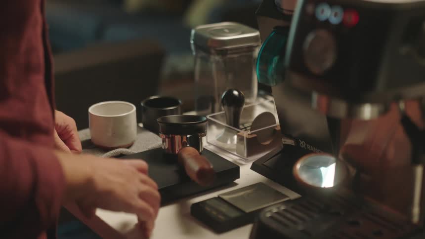 A person fills the coffee machine