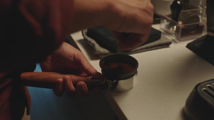Closeup of a mans hands preparing a coffee manually in an ampoule