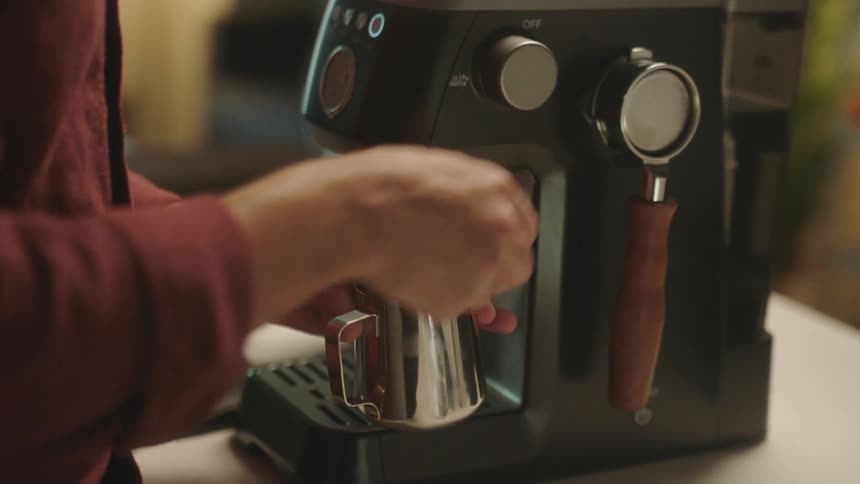 A person taking coffee from a coffee machine