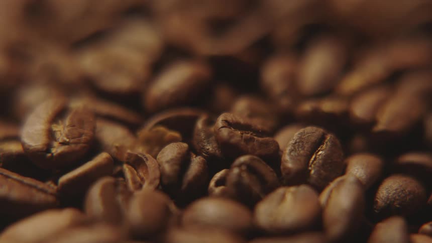 Several brown coffee beans
