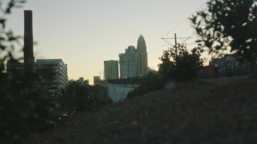 Landscape of ground overlooking buildings in a metropolis with the dawn sky