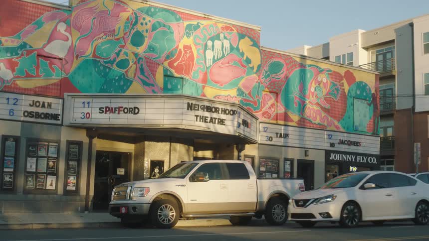 The facade of a cinema with colorful painted art