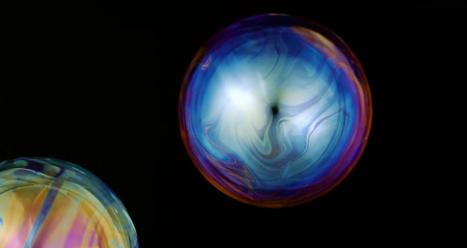 Colorful abstract water bubbles on a black background in slow motion
