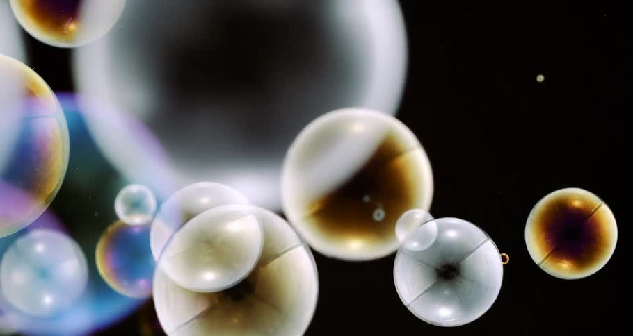 Various soap bubbles full of colors on a black background