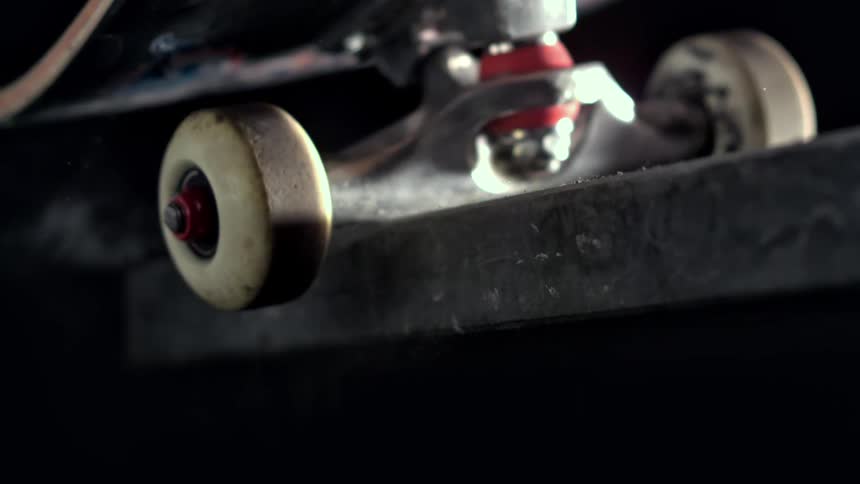 Extreme closeup of skateboard wheels in slow motion