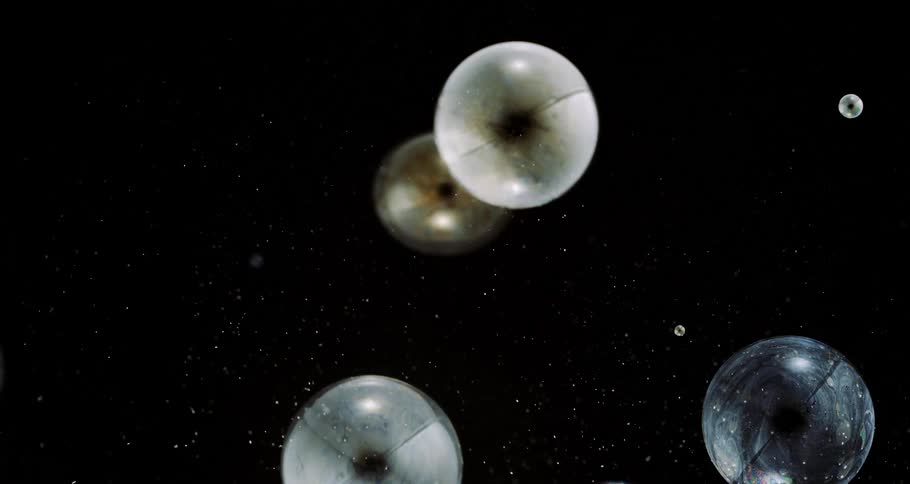 Huge bubble bursting with other small ones inside in slow motion