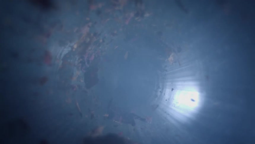 Debris and smoke twist down the tube