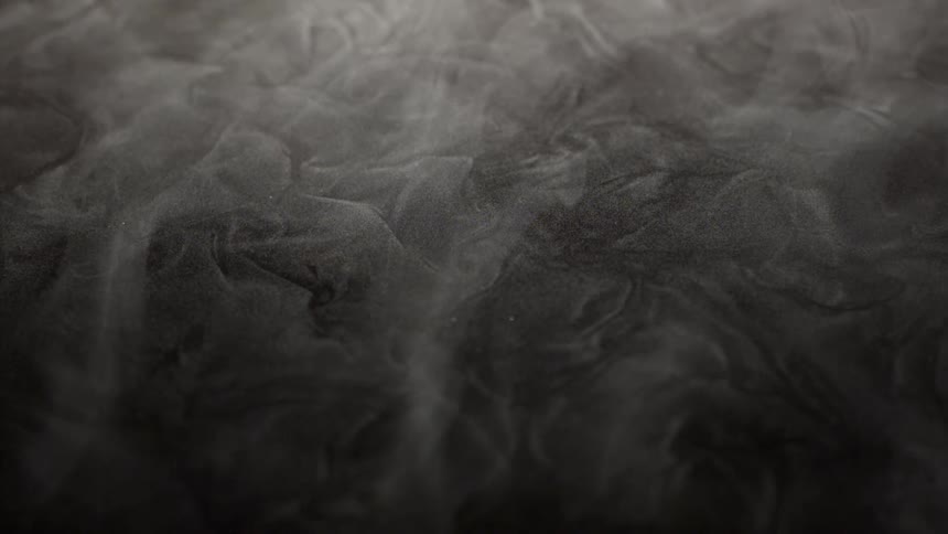 Extreme closeup of ground with abstract smoke flowing in slow motion